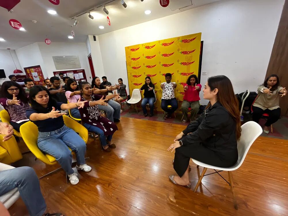 Vibha Jain conducting a hypnotherapy workshop with a seated group of participants