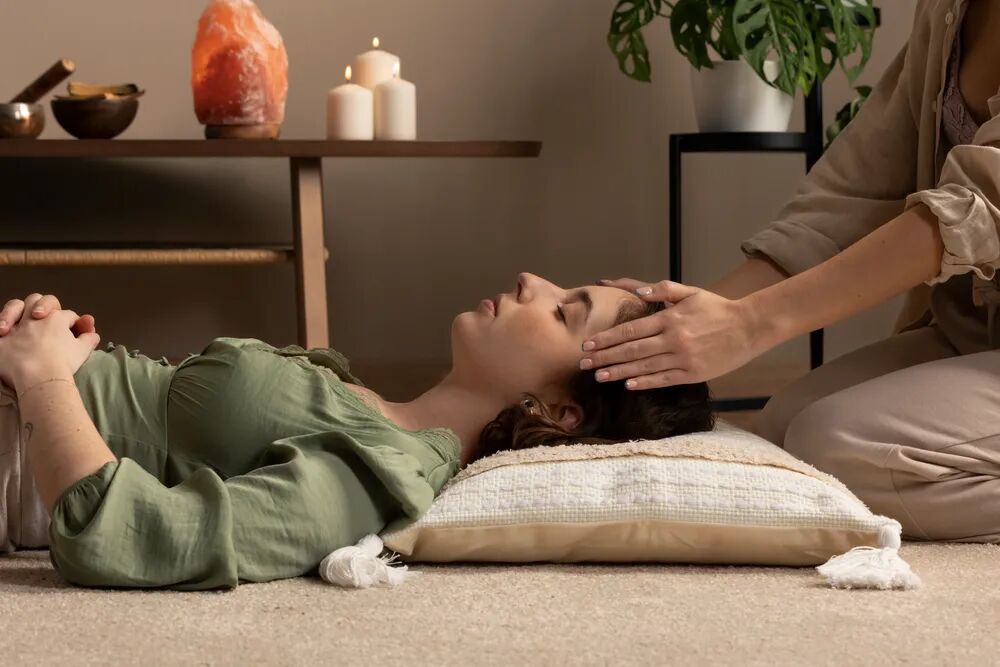 A person resting comfortably as a practitioner guides the beginning of a session